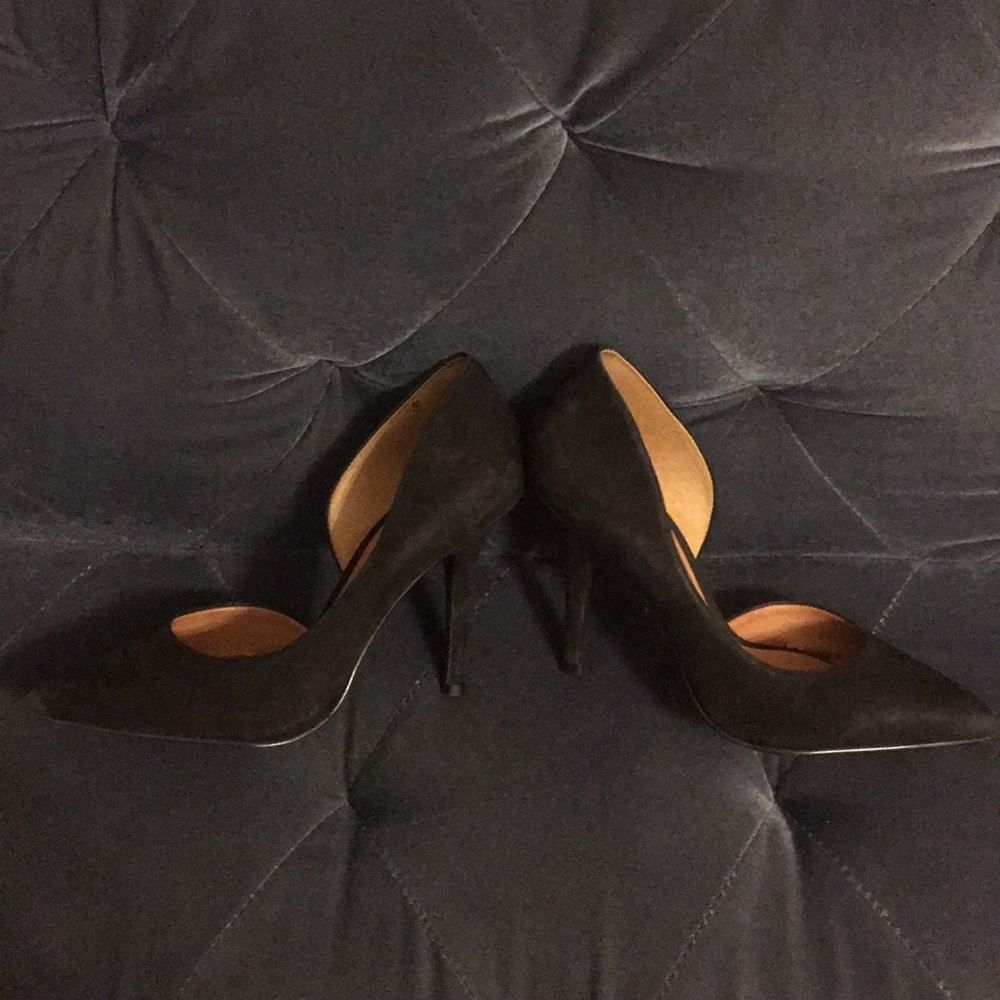 Black suede pumps with arch cutout.